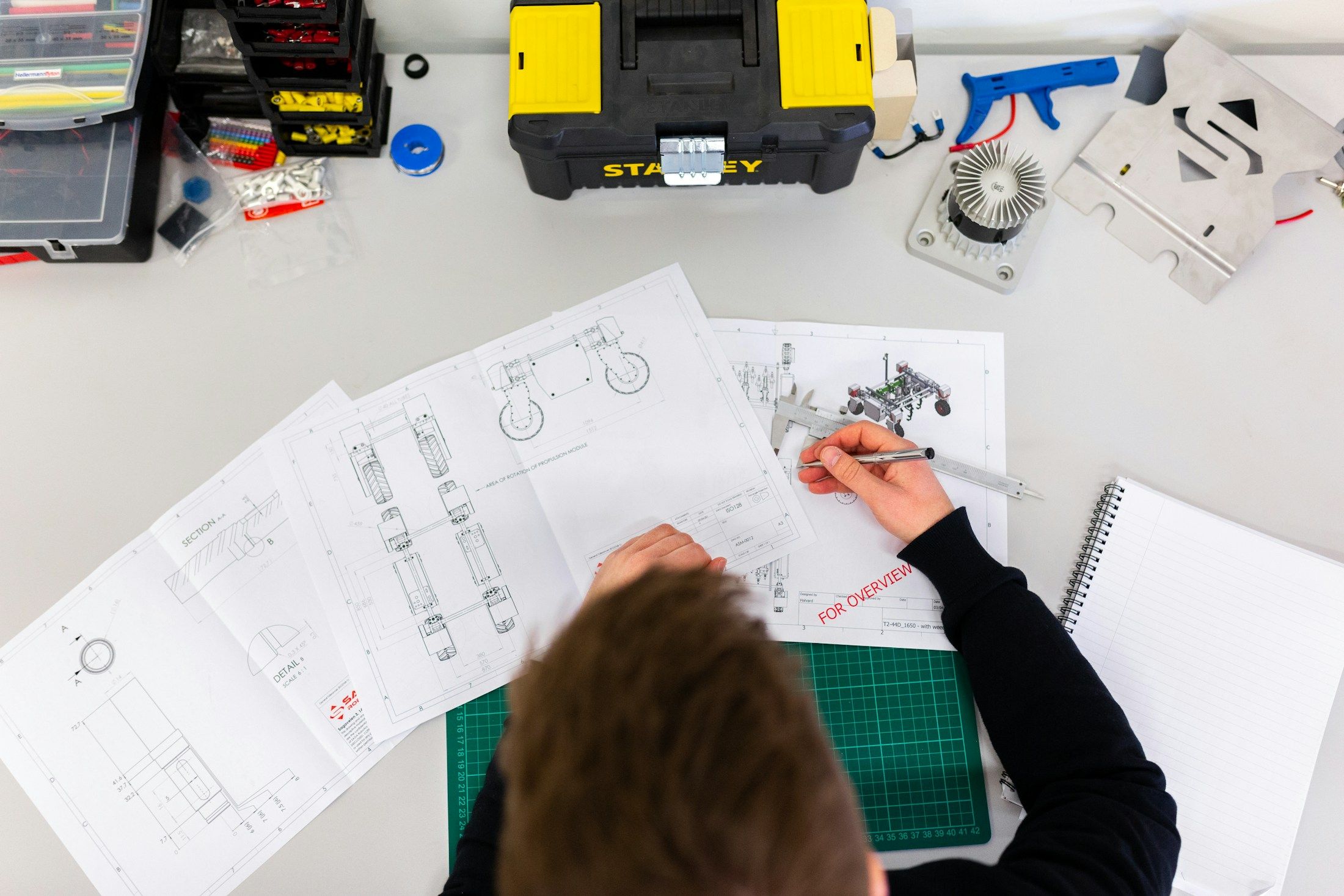 Engineers planning a product on paper