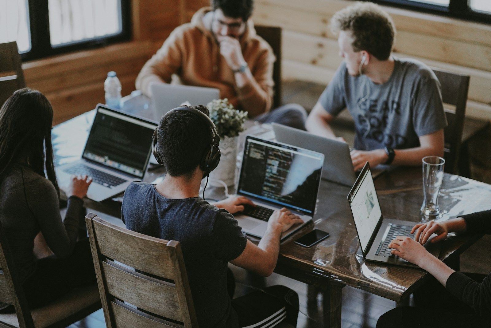 A product team collaborating around laptops